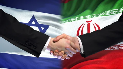 Handshake between Iranian and Israeli representatives with flags